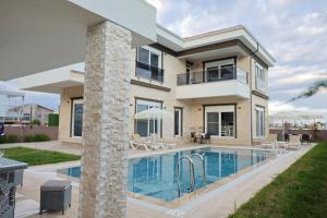 a house with a swimming pool in front of it at Vıllaozden in Belek