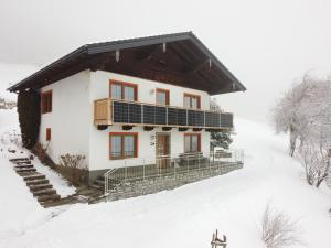 a house in the snow with solar panels at Ferienhaus Englbrecht in Krispl