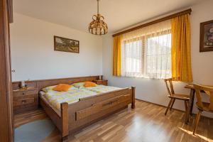a bedroom with a bed and a table and a chair at Ferienhaus Englbrecht in Krispl