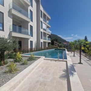 a swimming pool in front of a building at Olive residence A8 in Petrovac na Moru