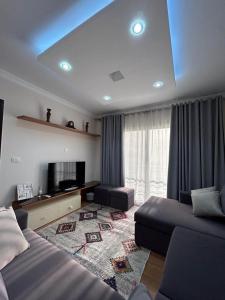 a hotel room with two beds and a flat screen tv at Decent brand new flat with garden view in New cairo
