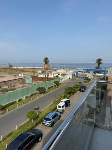 a highway with cars parked on the road near the beach at Ballestas Suite in Pisco