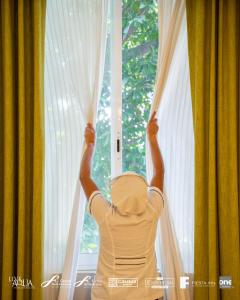 a man opening a window with his arms up at Gamma Cuernavaca Puerta Paraiso in Cuernavaca