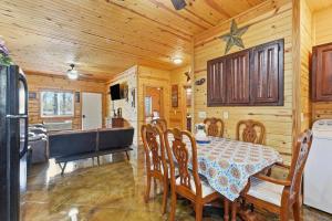 a dining room with a table and a bath tub at Quail Cove Oak Premium Lakefront Condo Boat Slip in Shell Knob