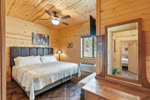 a bedroom with a bed and a ceiling fan at Quail Cove Oak Premium Lakefront Condo Boat Slip in Shell Knob +39 photos