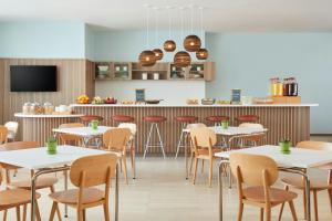 a restaurant with tables and chairs and a bar at Element by Marriott San Diego Chula Vista in Chula Vista