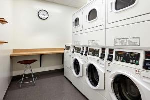 a laundry room with three washer and dryer machines at Element by Marriott San Diego Chula Vista in Chula Vista
