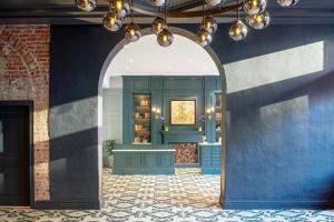 an archway in a room with blue walls at The Eliza Jane, Autograph Collection in New Orleans