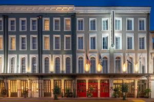 a large white building with flags in front of it at The Eliza Jane, Autograph Collection in New Orleans