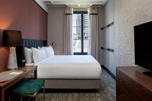 a hotel room with a bed and a television at The Eliza Jane, Autograph Collection in New Orleans +53 photos