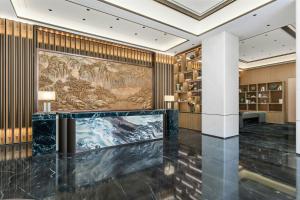 a lobby with a large painting on the wall at Fairfield by Marriott Yulin in Yulin