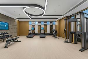 a gym with several treadmills and cardio machines at Fairfield by Marriott Yulin in Yulin