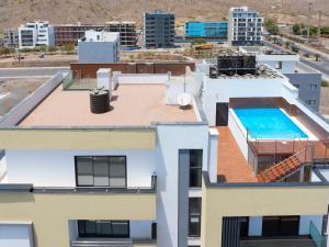 an aerial view of a building with a swimming pool at Modern 2-bdr apt with rooftop pool - LCGR in Praia