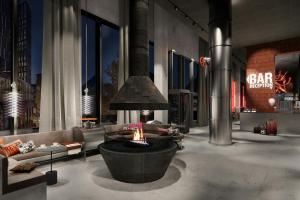 a rendering of a living room with a fire pit at Moxy Aarhus in Aarhus