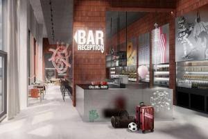 a bar with luggage and a bar reception at Moxy Aarhus in Aarhus