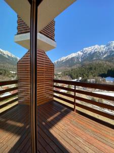 a balcony of a house with mountains in the background at Panorama Pietrei Craiului in Zărneşti +14 photos