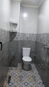 a bathroom with a toilet and a shower at Maison marhaba2 app 3 in Agadir