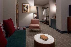 a living room with a couch and a chair at The Eliza Jane, Autograph Collection in New Orleans