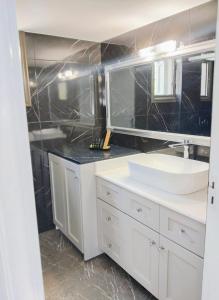 a bathroom with a white sink and a mirror at Anasa house in Symi +37 photos