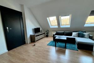 a living room with a couch and a tv at Apartmán Gabi in Lučenec