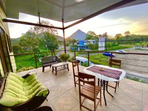 a patio with a table and chairs on a balcony at Arenal Views, Pool & 5min to Waterfall & Town in Fortuna