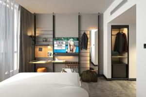 a bedroom with a white bed and a closet at Moxy Belgrade Skadarlija in Belgrade