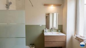 a bathroom with a sink and a shower at La Suite Vegetale Studio Prestige Hyper Centre in Mâcon +4 photos