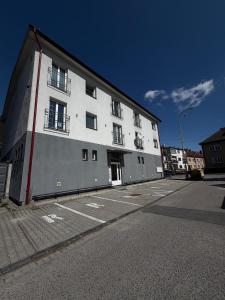a large white building on the side of a street at Apartmán pod Čebraťom in Ružomberok