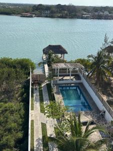 ein Haus mit Swimmingpool neben einem Gewässer in der Unterkunft Jato Hotel Boutique in Tuxpan de Rodríguez Cano