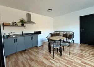 a kitchen and dining room with a table and chairs at Apartmán Gabi in Lučenec