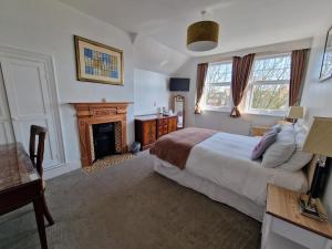 a bedroom with a bed and a fireplace at Shearwater in Bridlington