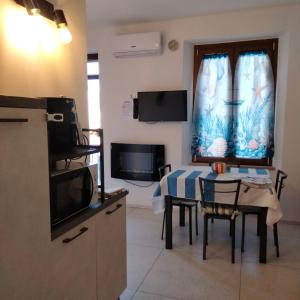 a small kitchen with a table and a microwave at Appartamento Giuse Mari in Suvereto +12 photos