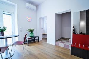 a living room with a table and chairs at Casa Lomè - Dimora Vacanze in Conversano +18 photos