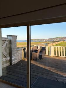 a view of a deck from the outside of a house at Beautiful Seaside Cottage Wicklow town in Wicklow
