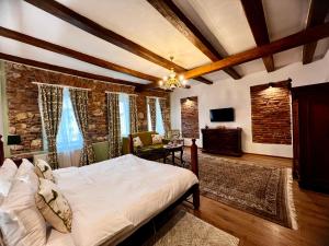 a bedroom with a large bed and a living room at Casa Ceauș in Baia-Sprie