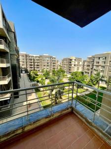 a balcony with a view of a city at Decent brand new flat with garden view in New cairo