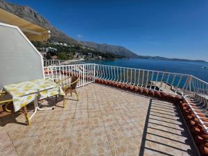 a balcony with a table and chairs and the water at Guest House Daniela in Mlini +52 photos
