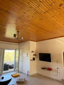 ein Wohnzimmer mit Holzdecke in der Unterkunft Kampos View in Ágios Nikólaos