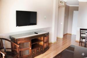 a living room with a flat screen tv on a wall at MC La Quinta in Santa Úrsula