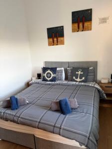 a bedroom with a large bed with blue pillows at Beautiful Seaside Cottage Wicklow town in Wicklow