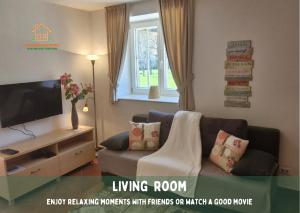 a living room with a couch and a tv at Pardubsky Apartments in Ljubljana