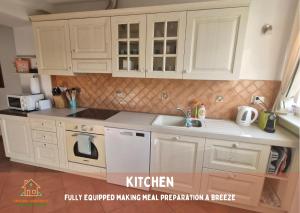 a kitchen with white cabinets and a sink at Pardubsky Apartments in Ljubljana