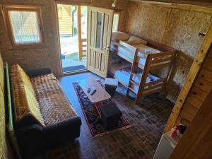 a small room with a couch and a bunk bed at Camp Volujak in Gacko +11 photos