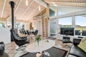 a living room with a table and chairs and a tv at OH118-Storvorde-Kongeornen-32 in Storvorde