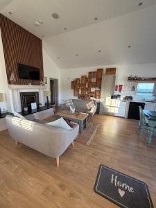 a living room with a couch and a table at Beautiful Seaside Cottage Wicklow town in Wicklow
