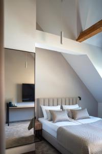 a bedroom with a white bed with a roof at Villa Aria in Krynica Zdrój