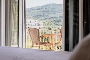 a bedroom with a view of a table and chairs at Theoni Garden in Parga