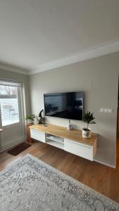 a living room with a flat screen tv at Keflavik Heart in Keflavík