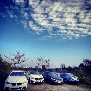 a group of three cars parked in a parking lot at After the Court Chiaohsi in Jiaoxi