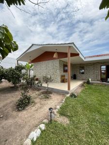 a brick house with a pavilion in a yard at Casa La Herencia in Huaral